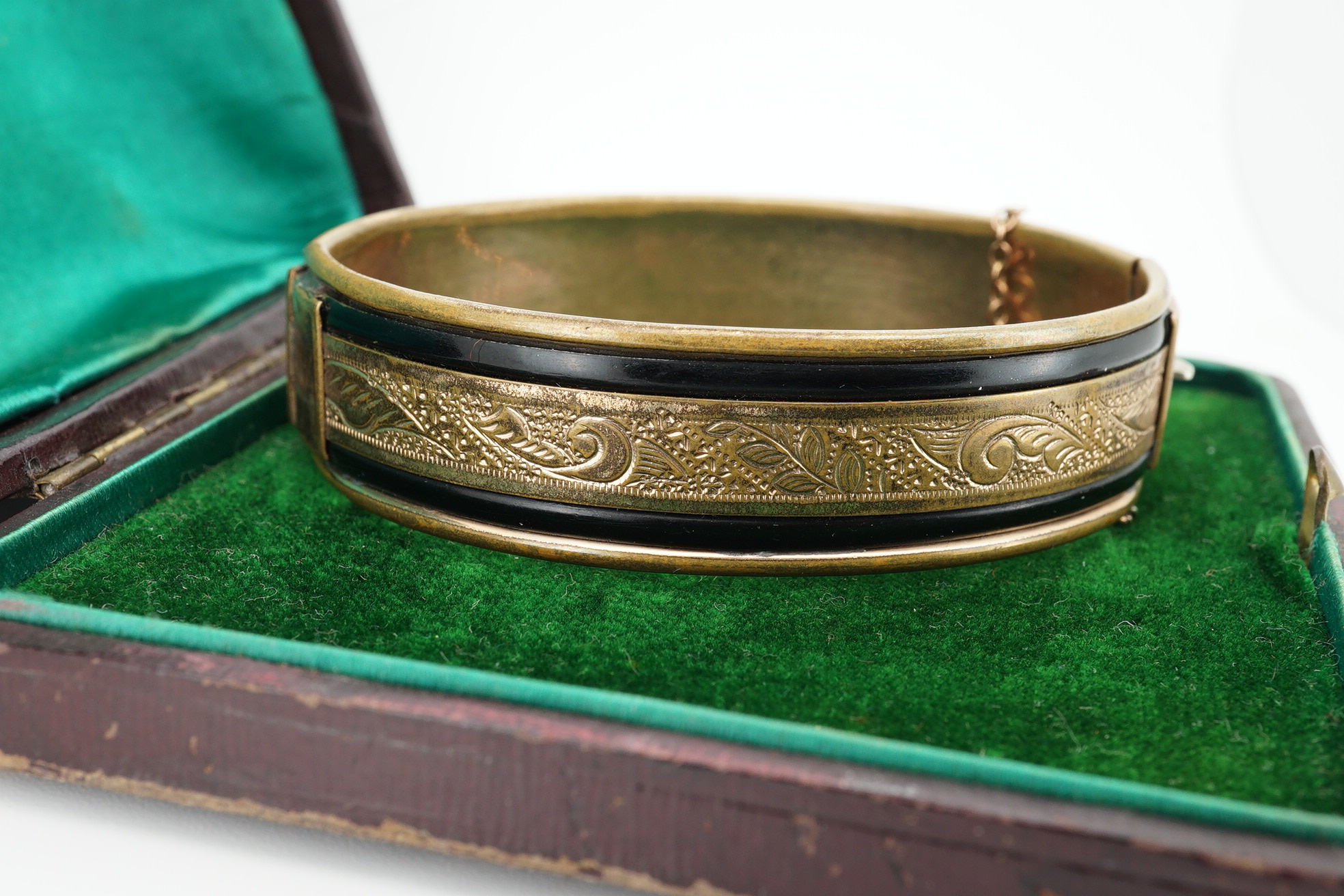 An Edwardian 9ct gold, and gypsy set ruby and diamond set hinged bangle, gross 11.4 grams, together with a gilt metal hinged bangle. Condition - poor.